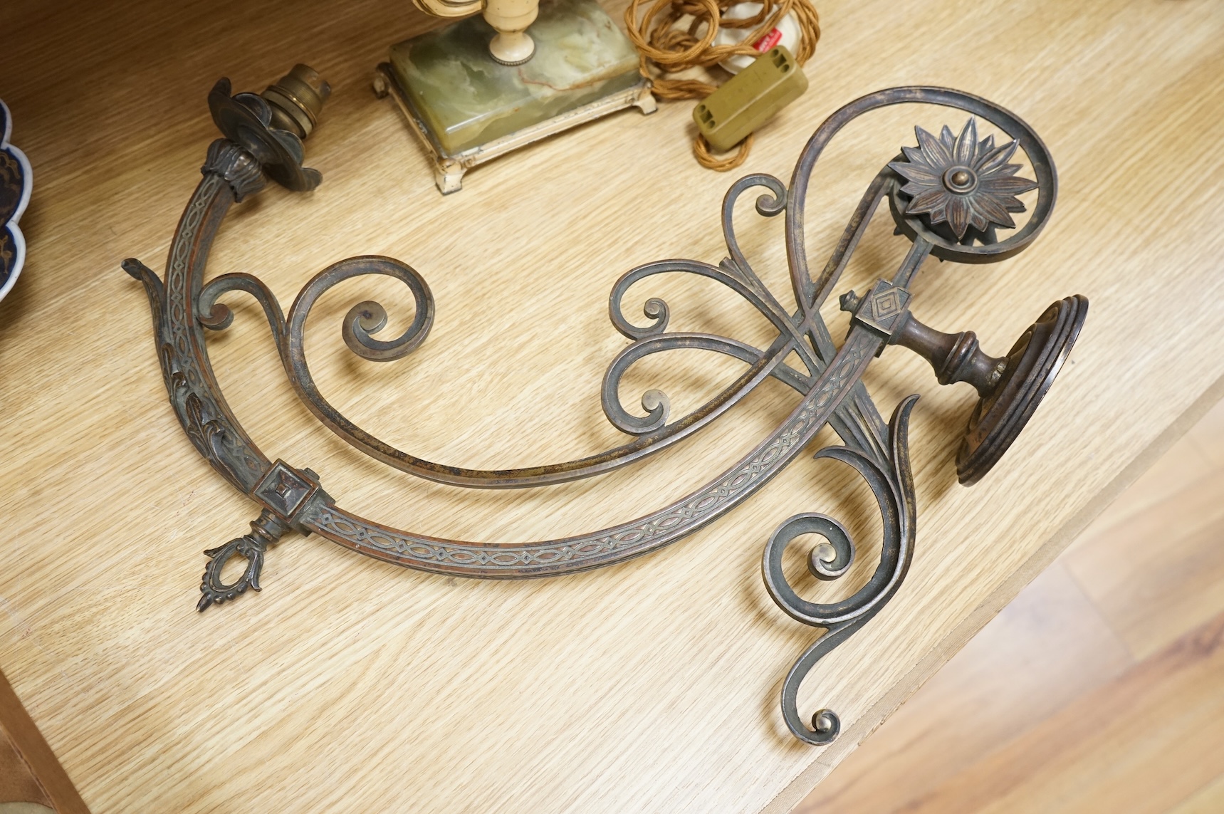 A cast brass wall sconce and a toleware two light lamp on onyx base, largest 46cm wide (2)
